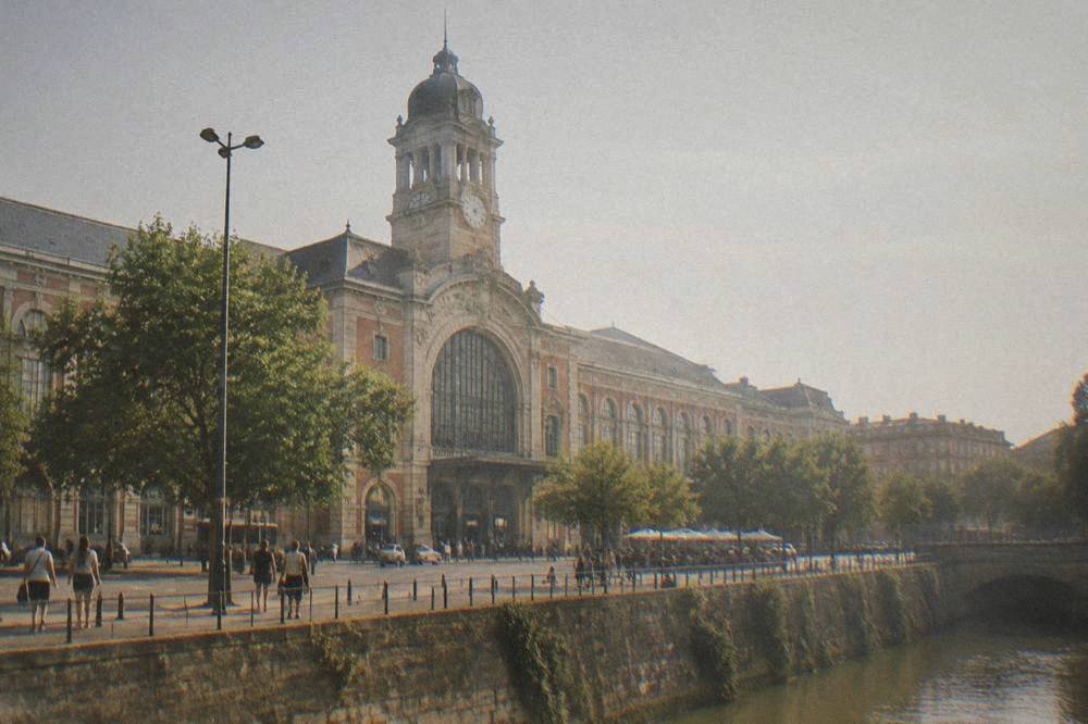 Toulouse-Matabiau train station seen from the street with its clock tower above the entrance
