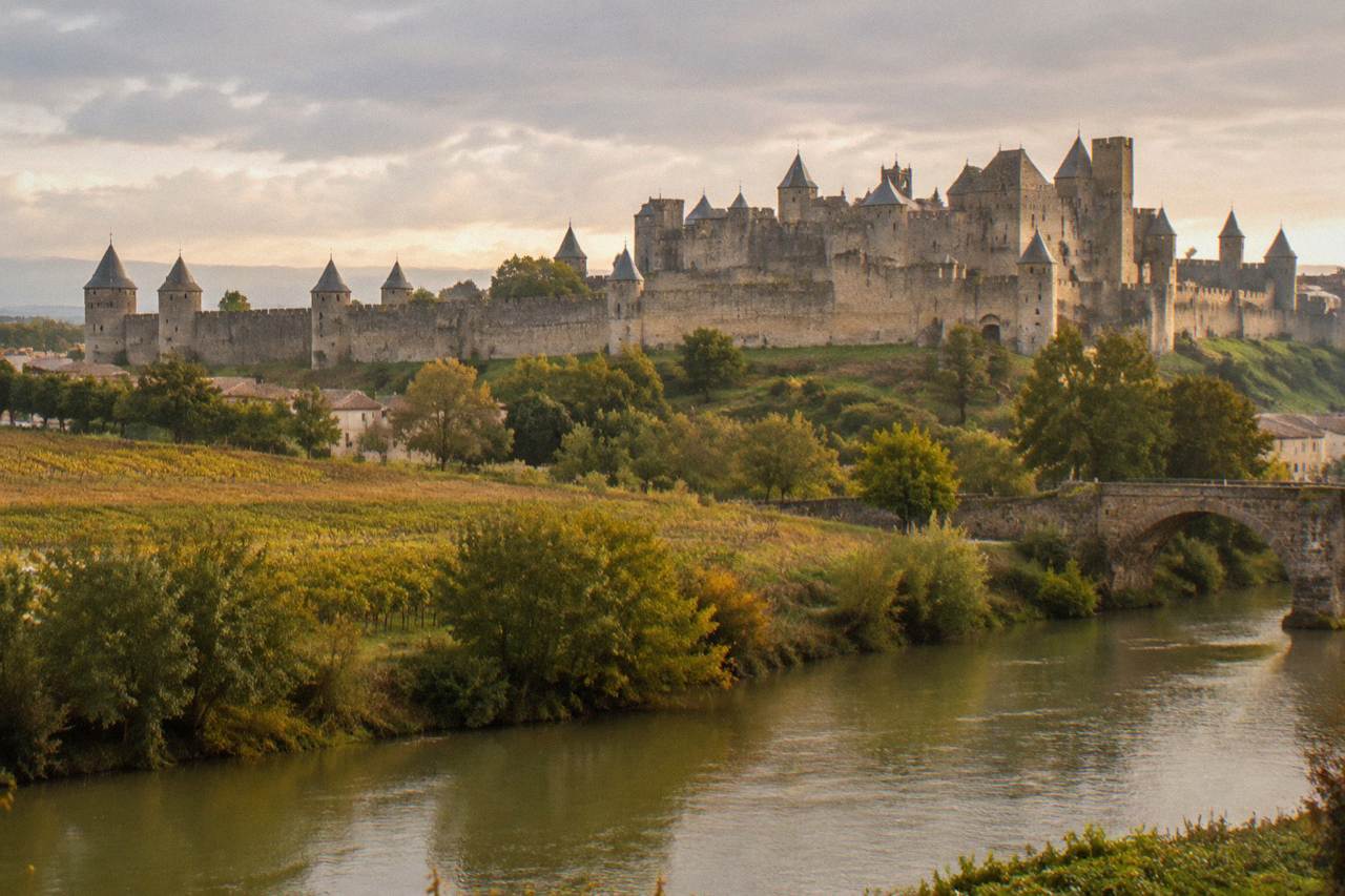 The fortified walls and pointed towers of Carcassonne rising above the surrounding countryside