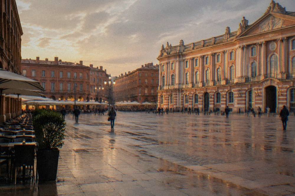 Pink brick buildings in Toulouse glowing in warm evening light near the Garonne river