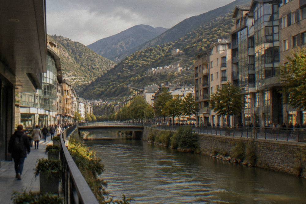 A mountain road winding toward Andorran peaks with stone villages below
