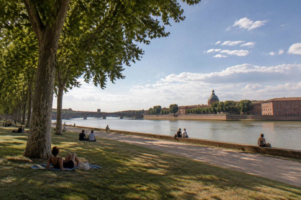 The Garonne riverside in Toulouse under a summer sky