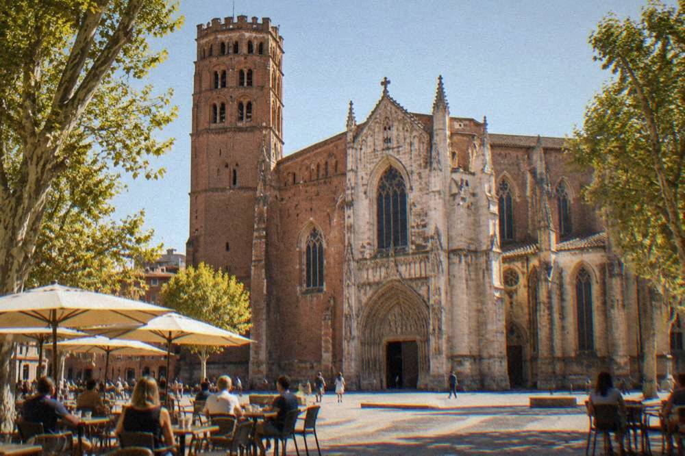 Cafe tables on the square in front of Saint-Etienne cathedral in Toulouse