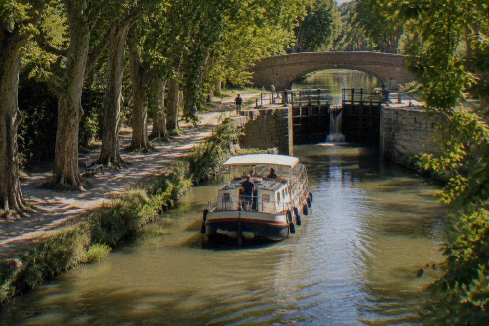 A canal boat approaching a lock gate on the Canal du Midi near Toulouse
