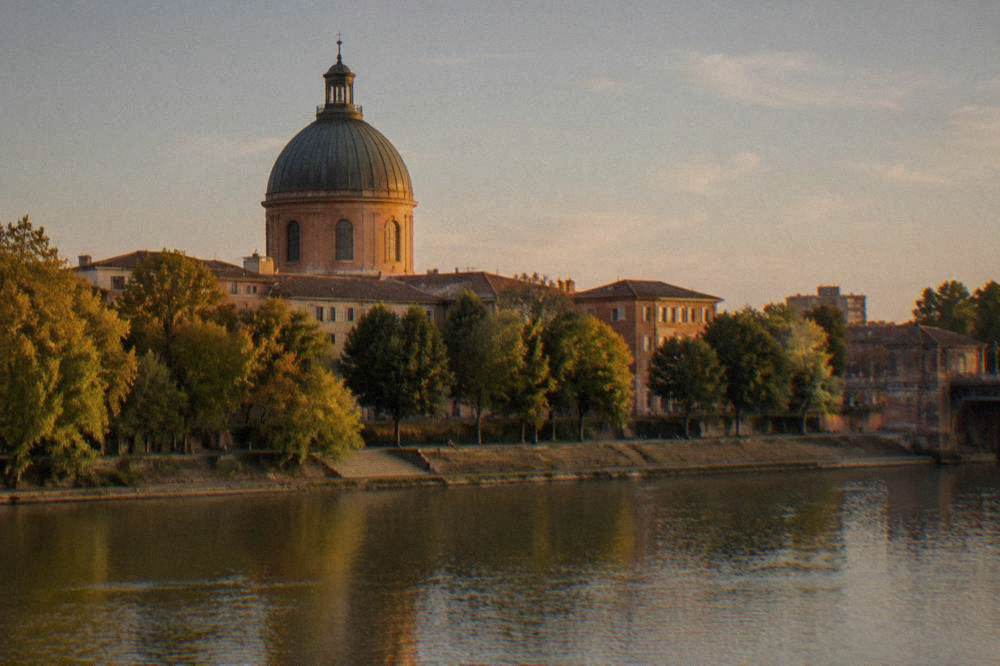 The dome seen from a bridge over the Garonne with the river in the foreground