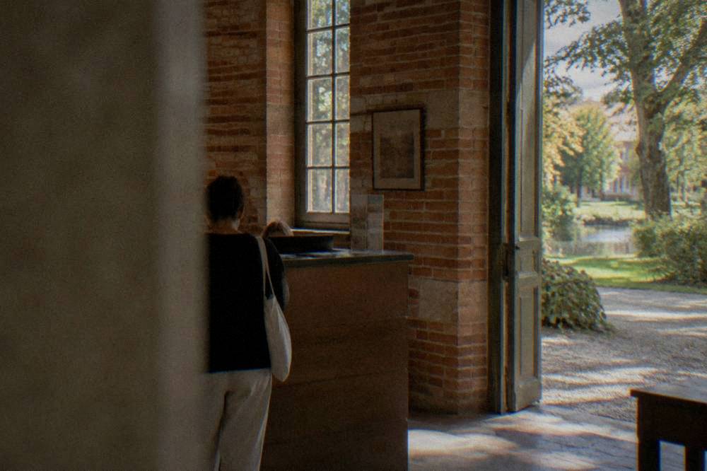 A museum ticket desk in a small brick entrance hall