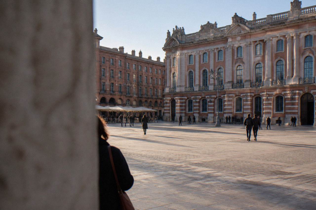 A historic museum building in Toulouse with an ornate stone facade and tall windows under a clear sky