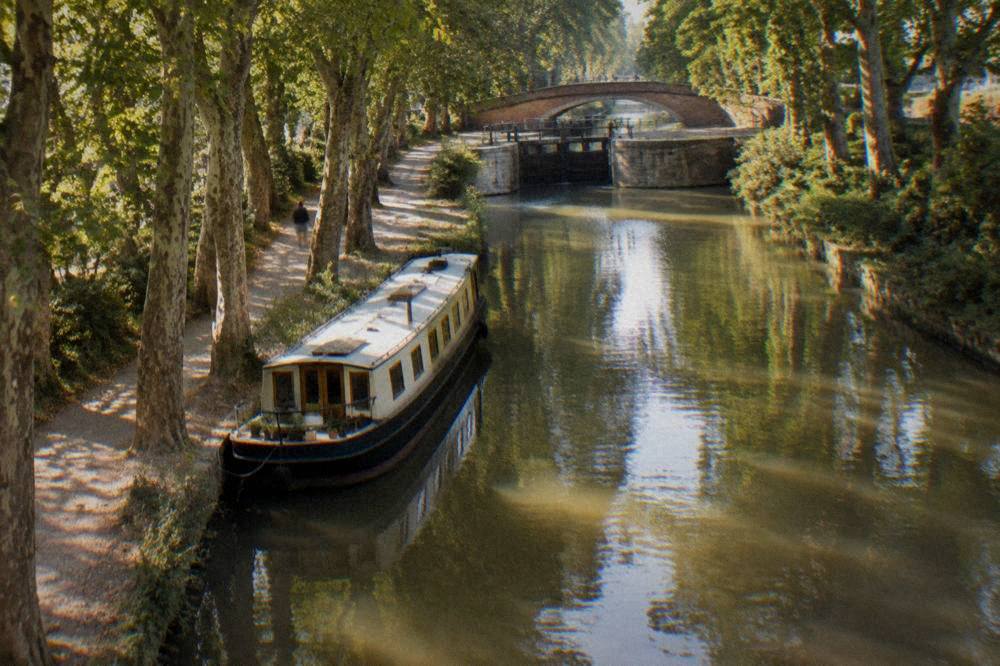 A canal boat moored on the Canal du Midi in Toulouse
