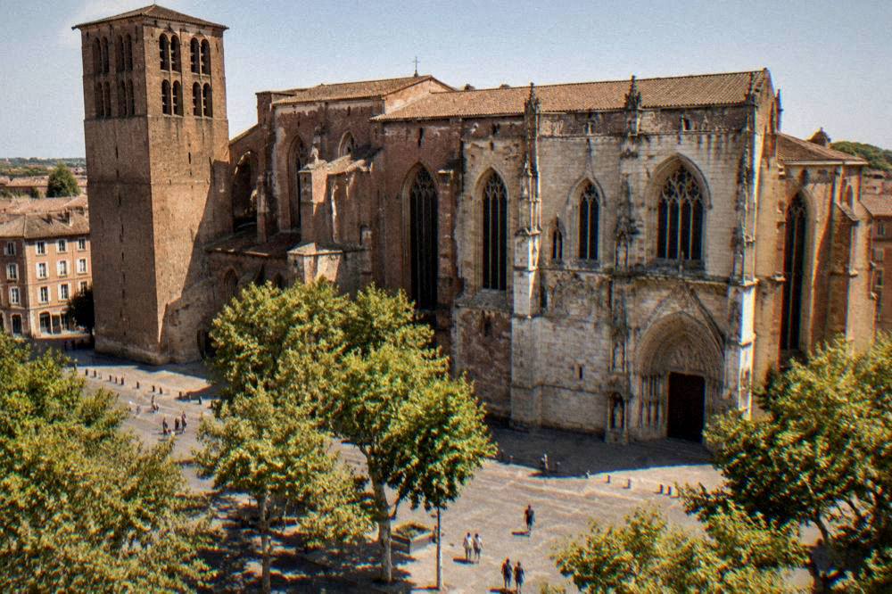 Sunlight falling on the brick walls of Toulouse Cathedral on a clear afternoon
