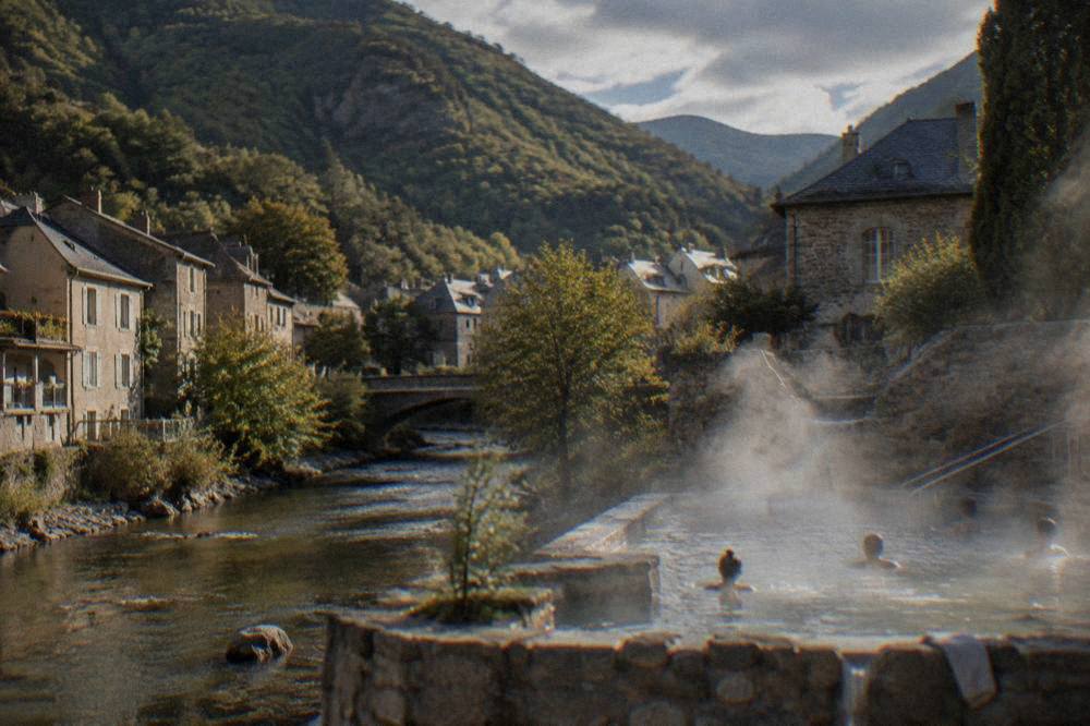 Steam rising from warm thermal water at an outdoor mountain pool