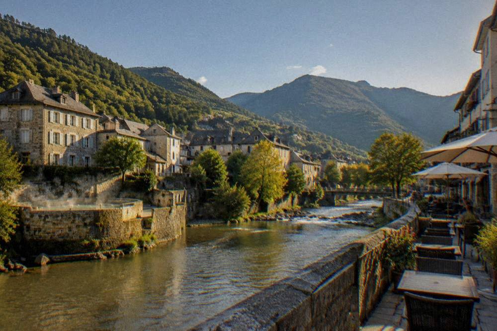 Warm evening light on a mountain town street with cafe tables