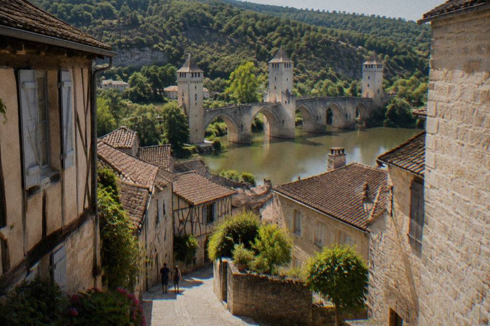 Narrow medieval lanes with half-timbered and stone houses in an old French town on a sunny afternoon