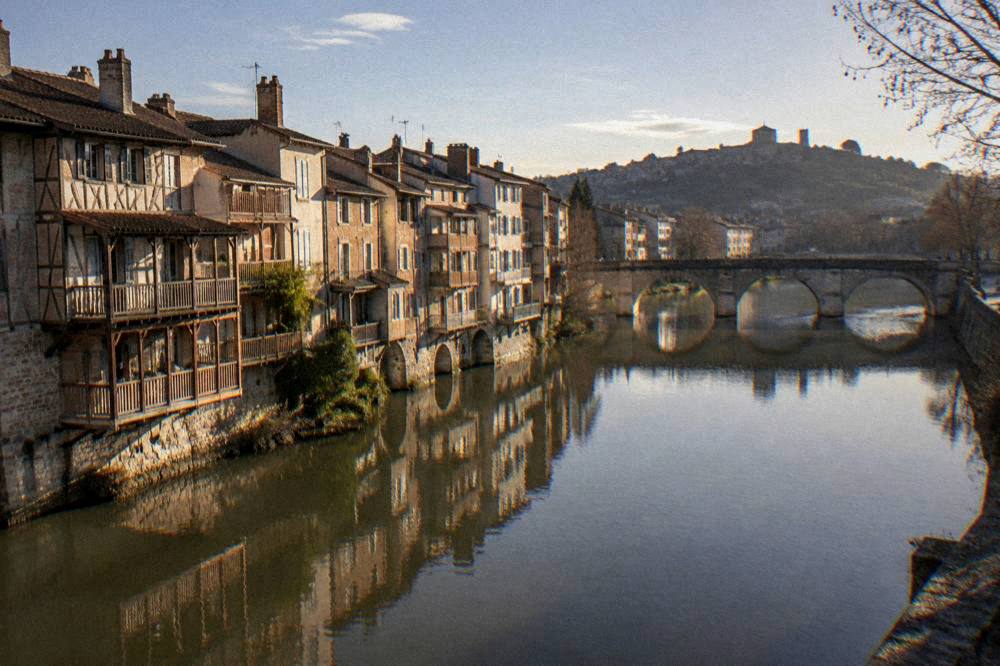 A hilltop village silhouetted against a wide sky in southern France