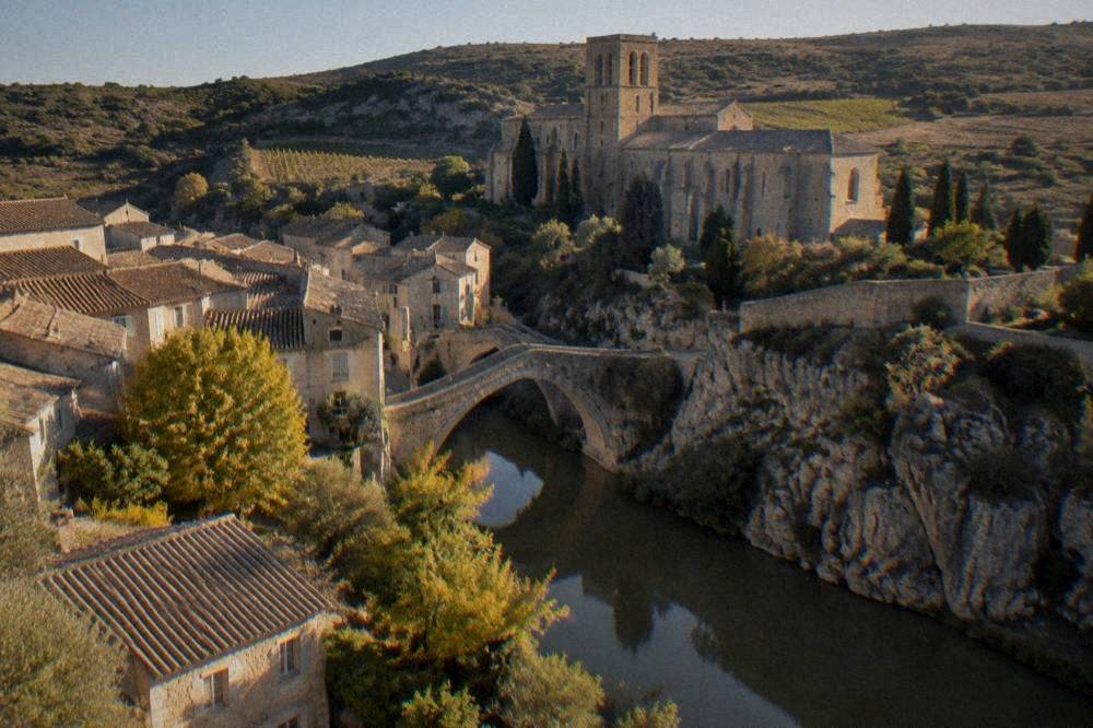 A village on a rocky spur above deep dry gorges with bare stone cliffs below