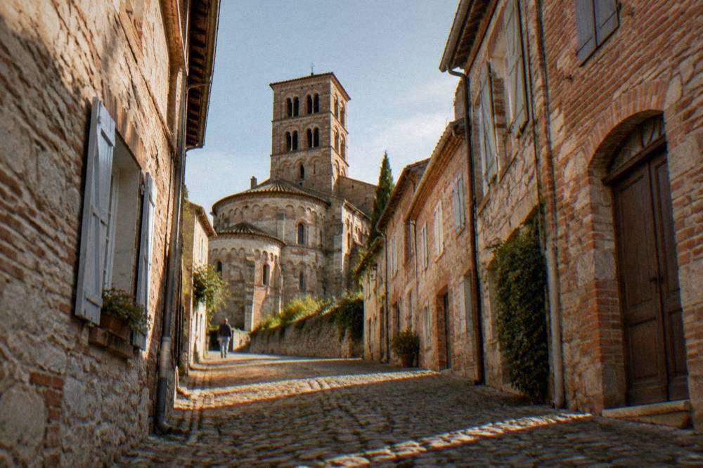 Narrow old street of brick and stone houses in the center of Moissac