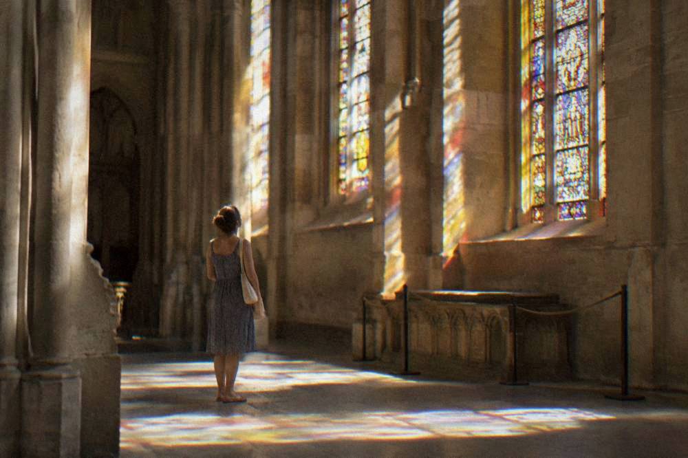 Sunlight falling through the stained glass windows inside Narbonne cathedral