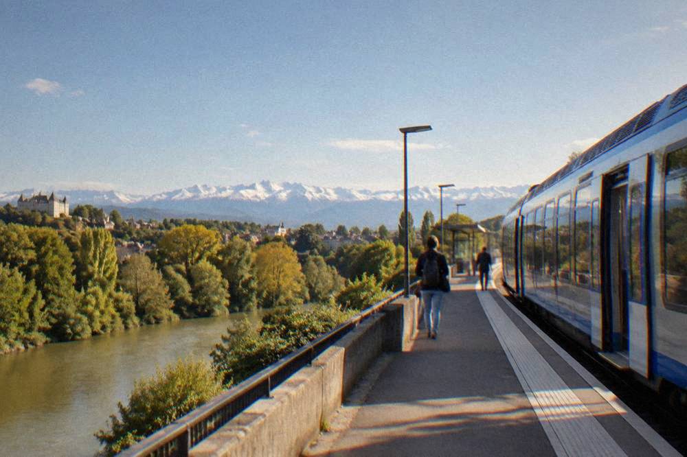A regional train waiting at a platform in a French railway station