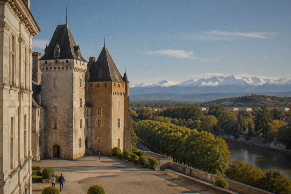 The stone facade and towers of the Chateau de Pau seen from its courtyard