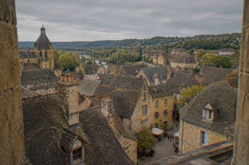 Rooftops of Sarlat seen from a church tower with golden stone chimneys