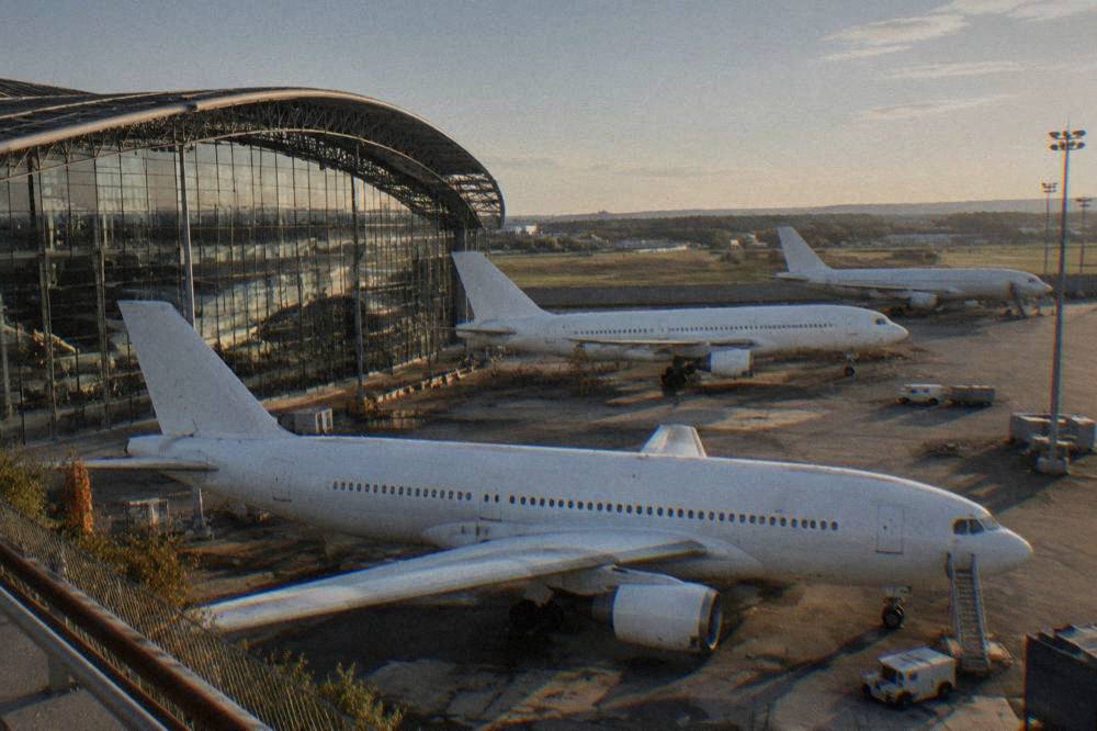 Interior of an aircraft assembly hall with fuselage sections and scaffolding