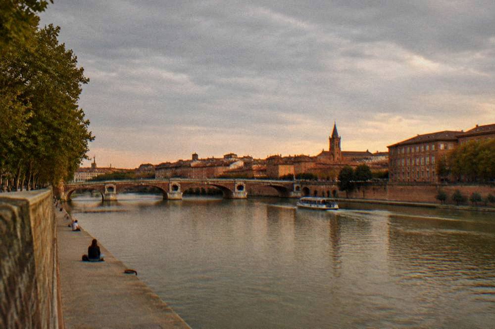 Evening light on the canal with the pink brick of Toulouse buildings beyond