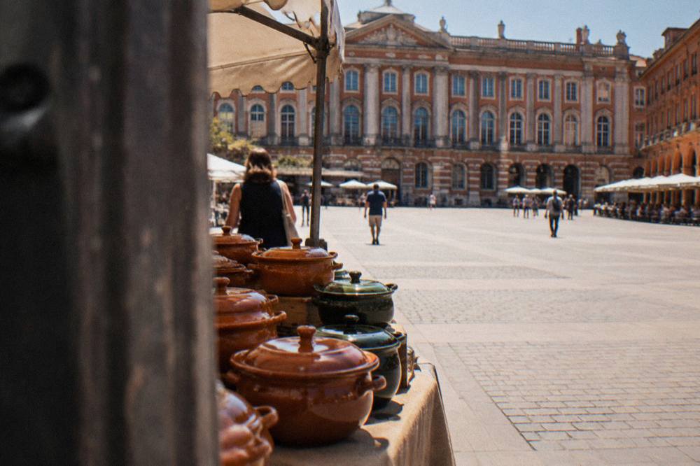 A glazed clay cassole pot for sale on a market kitchenware stall