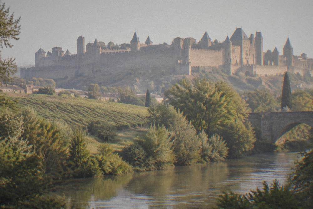 The walled medieval city of Carcassonne seen from below with its towers and slate roofs