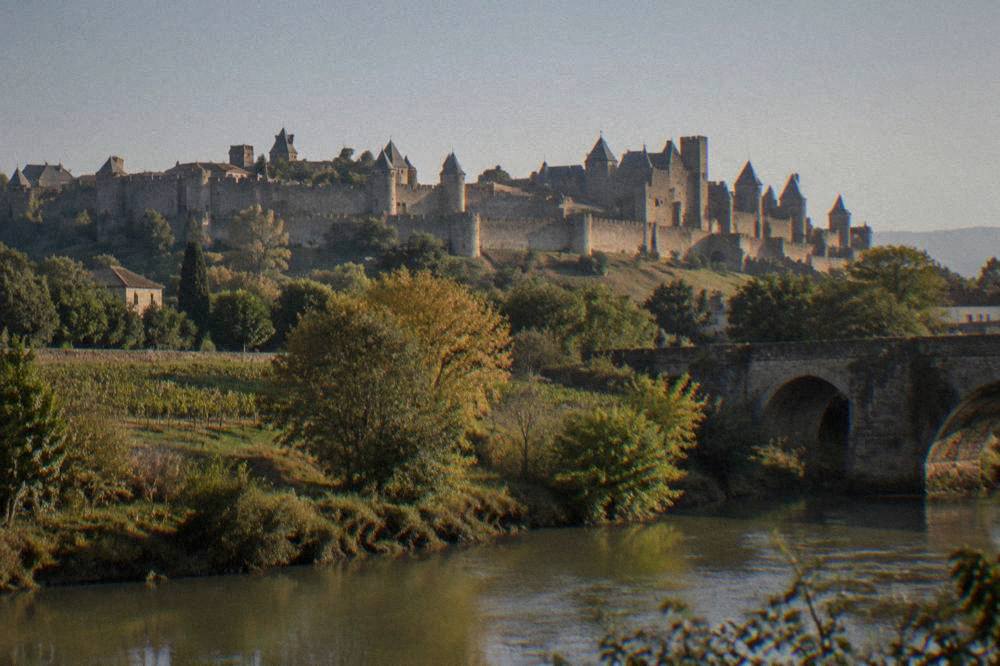 Walled medieval city of Carcassonne on a hill above a river under a clear sky