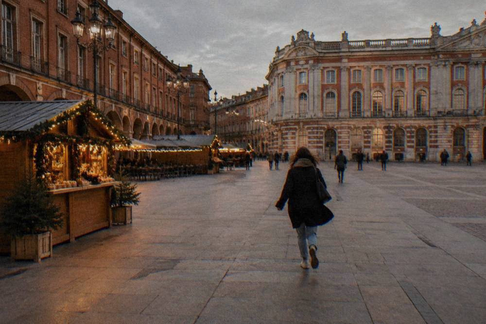 Wooden market chalet with festive garlands and warm lights in Toulouse