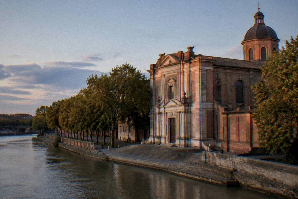 The facade of Notre-Dame de la Daurade beside the Garonne river in Toulouse