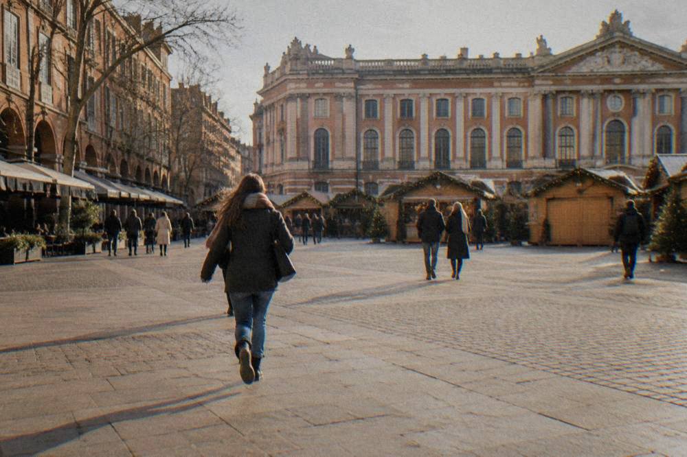 Wooden Christmas market chalets in front of the Capitole building in Toulouse