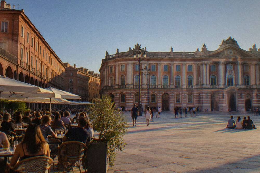 People gathered on a terrace square in Toulouse in the evening