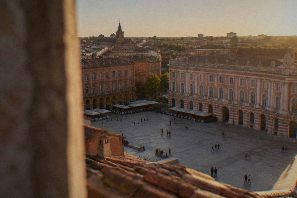 A rooftop view over the red tile roofs of central Toulouse