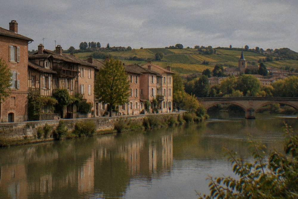 Vineyard hills and a small village on the Gaillac wine route near Toulouse