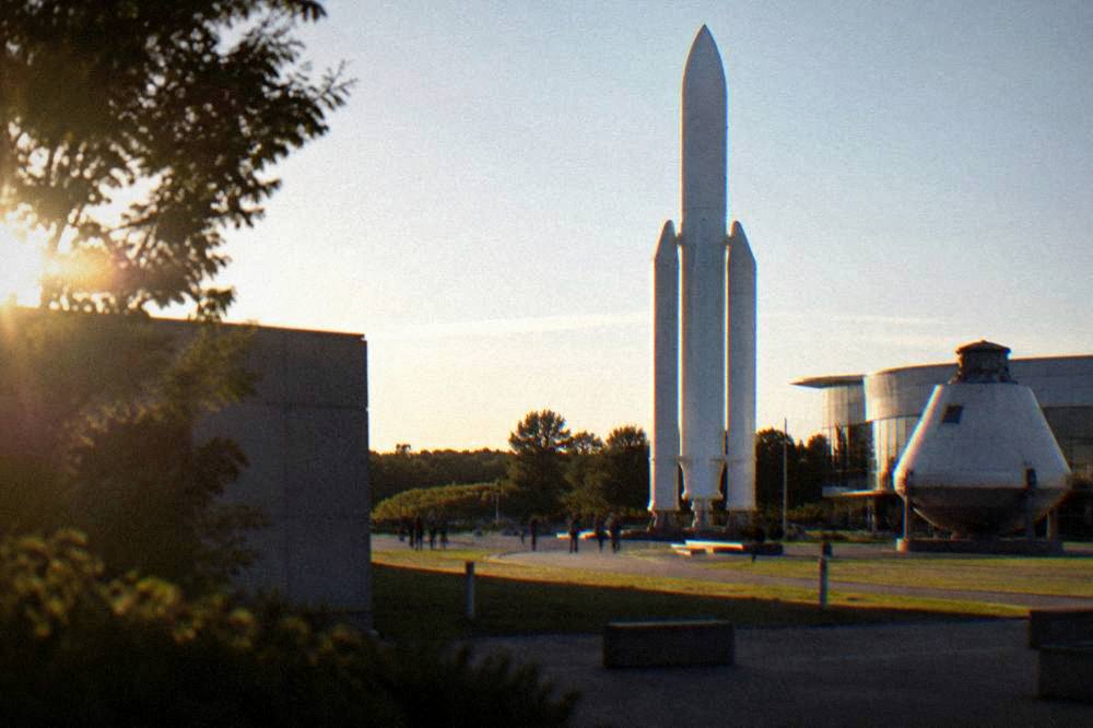 A rocket and spacecraft exhibits standing outside the Cite de l'espace in Toulouse