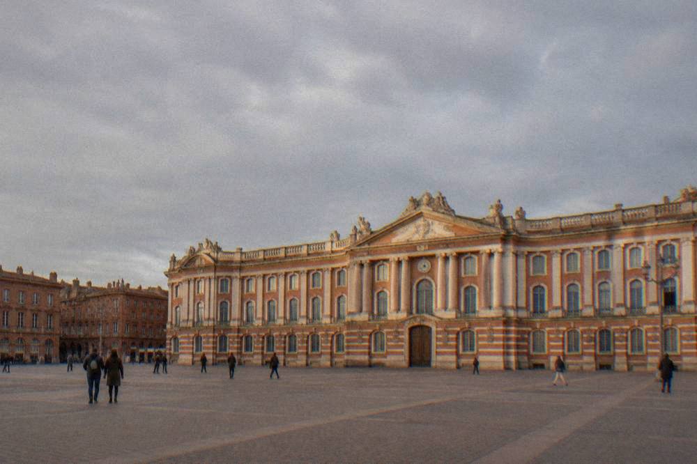 The wide Place du Capitole in Toulouse with its columned town hall facade