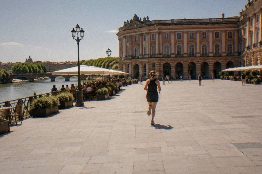 A sunny terrace with parasols beside the Garonne river in Toulouse