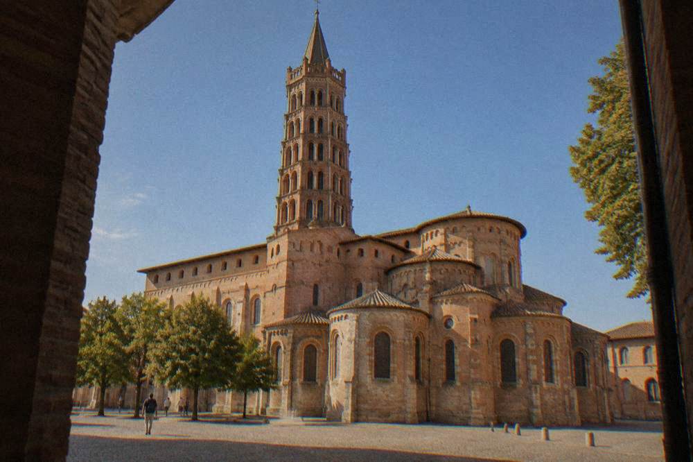 The Romanesque tower and facade of the Basilique Saint-Sernin in Toulouse