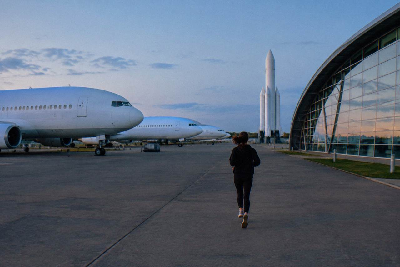 A rocket standing outside a space museum under a blue sky