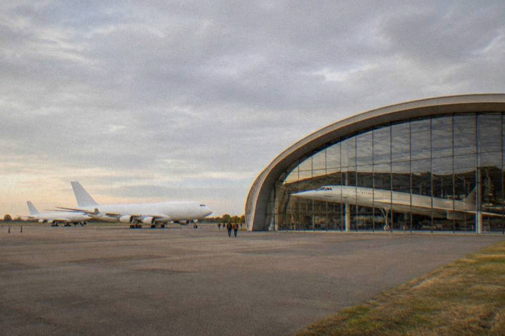 A supersonic airliner displayed inside a large museum hangar