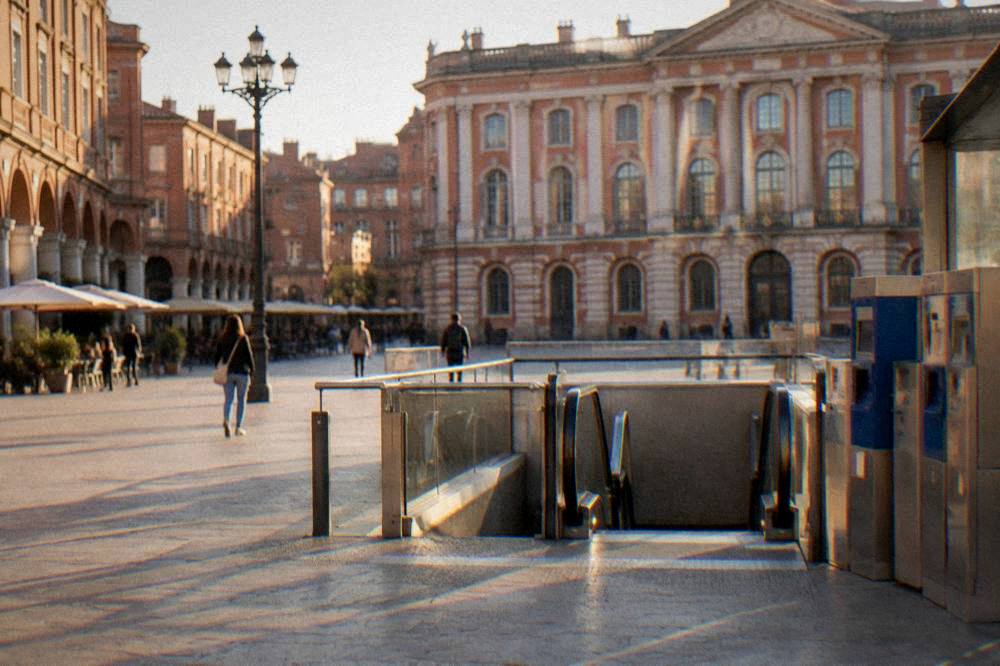 A metro station entrance with ticket machines in a European city