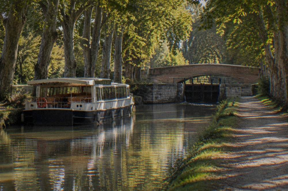 A passenger boat moored on the Canal du Midi in Toulouse at dusk
